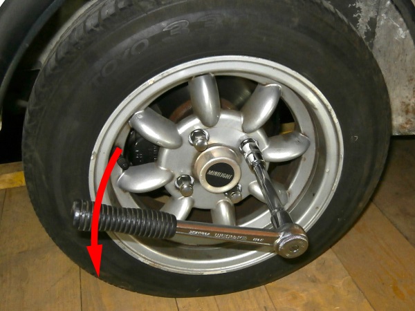 Slightly loosen the 4 nuts on the LH front wheel