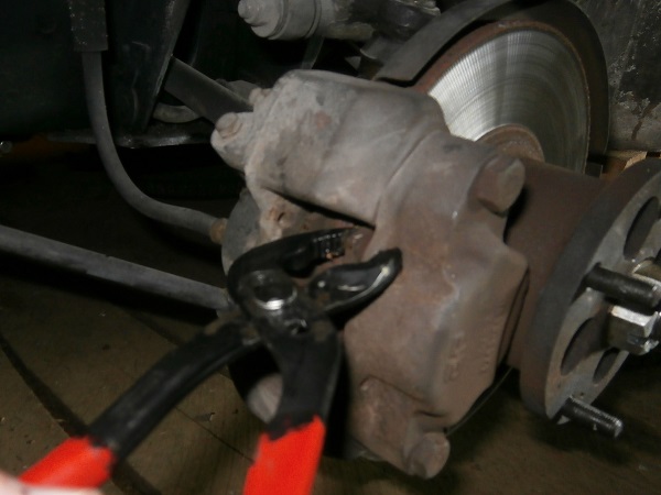 Push back the front brake caliper pistons on Mini classic