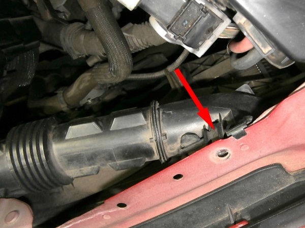 Clip the air inlet duct onto the upper front crossmember.